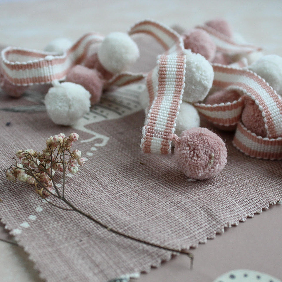 Blush pink and ghost white pompom trim with matching coloured braid over coordinating fabric