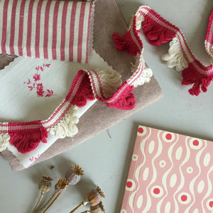 Cranberry and ivory fan edge trim over coordinating fabrics