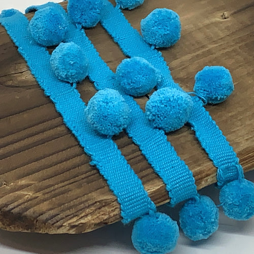 This is our plain teal pompom trim